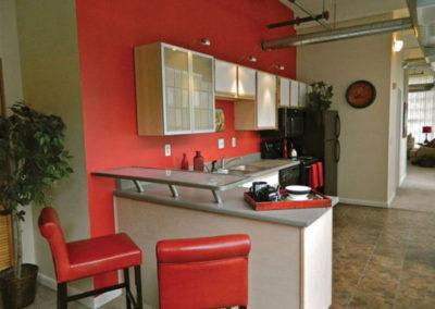 Kitchen with red walls and chairs at St Clair Lofts apartments for rent in Dayton, OH