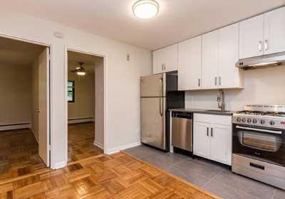 2-bedroom unit with updated kitchen with white cabinets and open concept living/dining room.